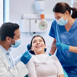 Smiling patient receiving a checkup from a dental team, highlighting dental care in Hubbard in a modern dental office