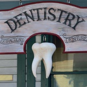 Vintage dentistry sign with a hanging tooth display, promoting a dental office near me in Austintown
